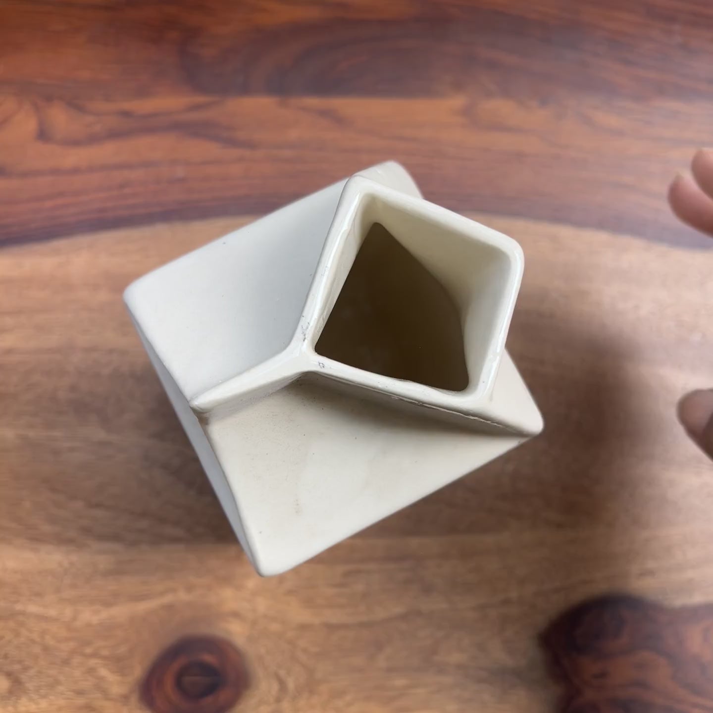 Product video of a white ceramic jug with black polka dots.