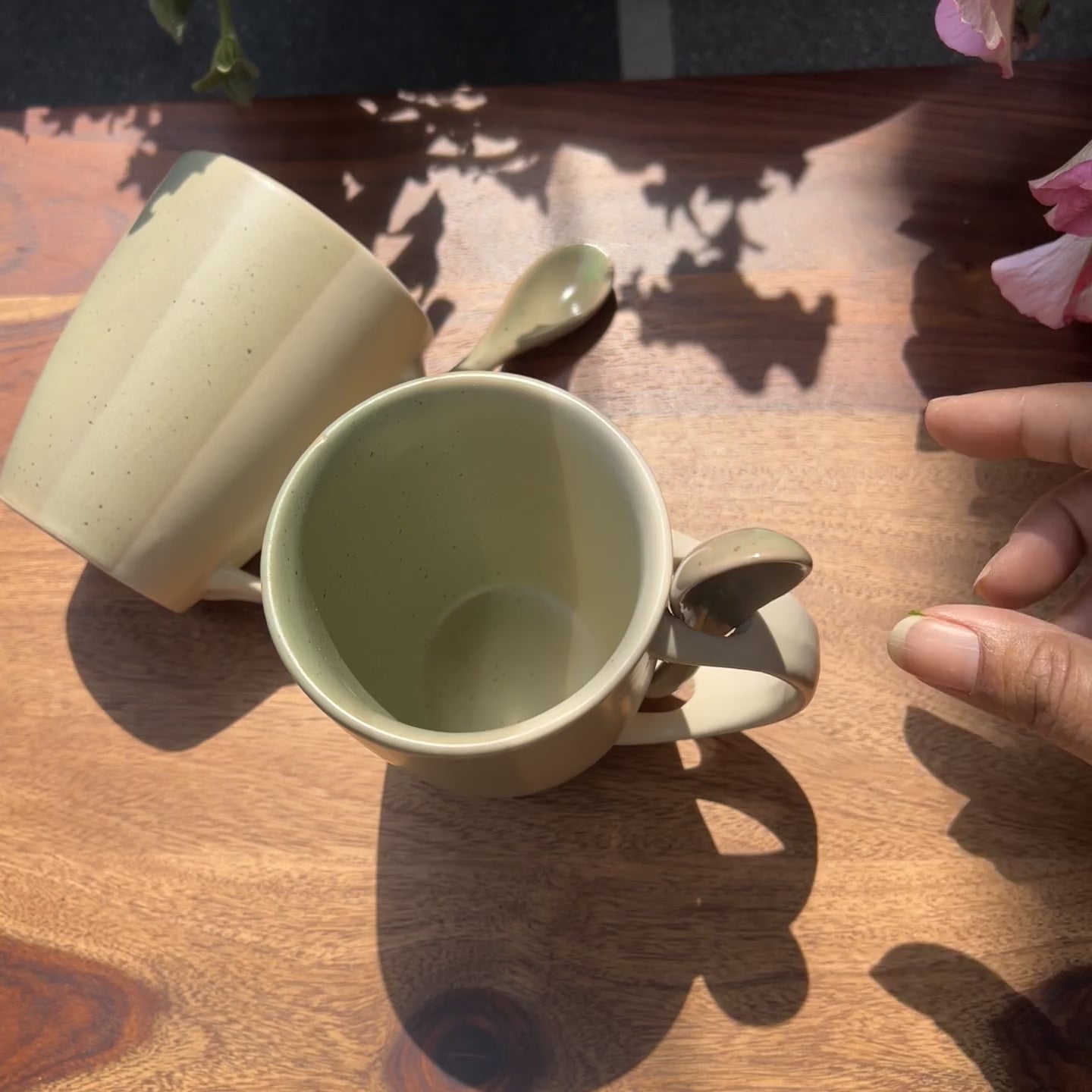 Product video of ceramic green and white cups with spoons.
