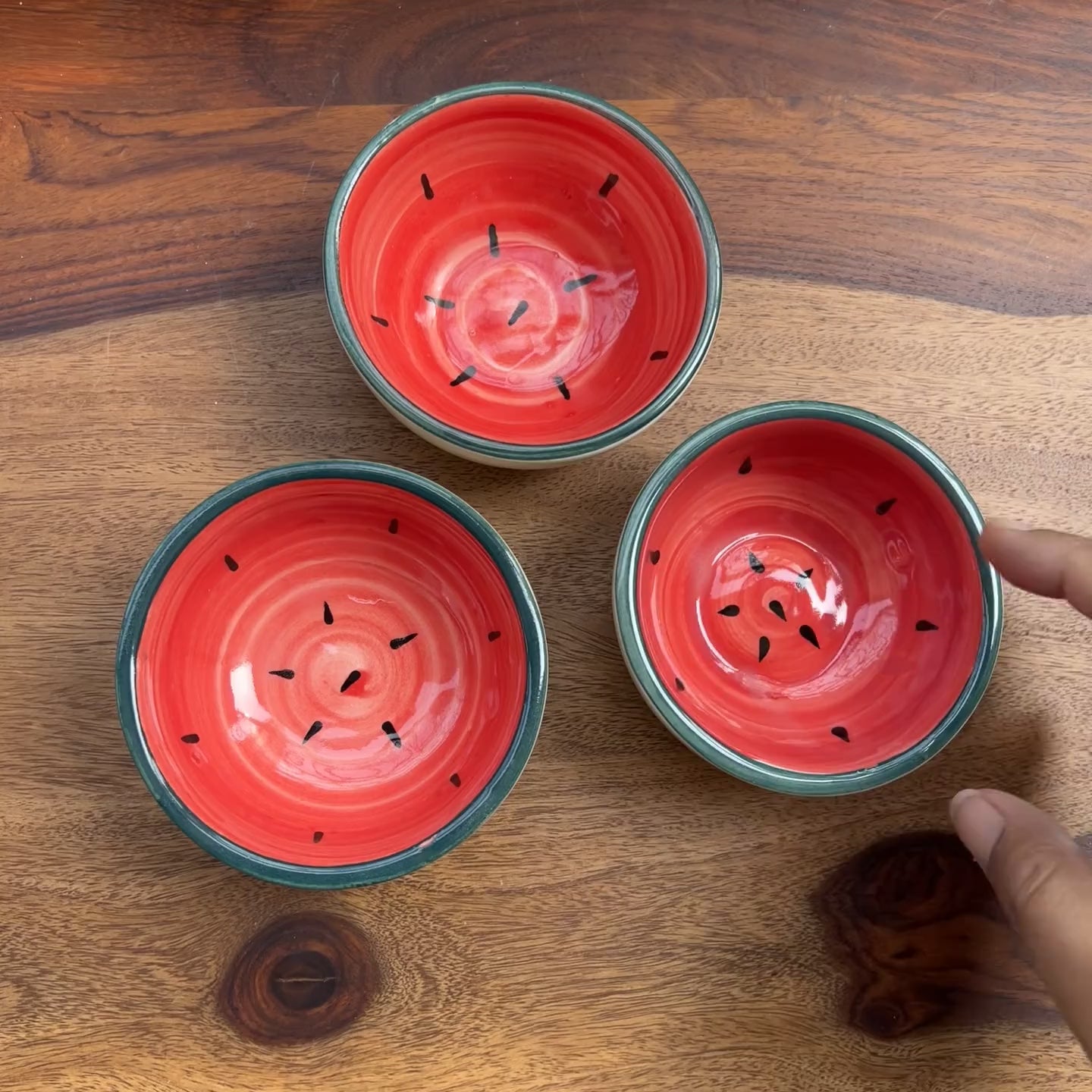 Product video of watermelon inspired red ceramic bowls.