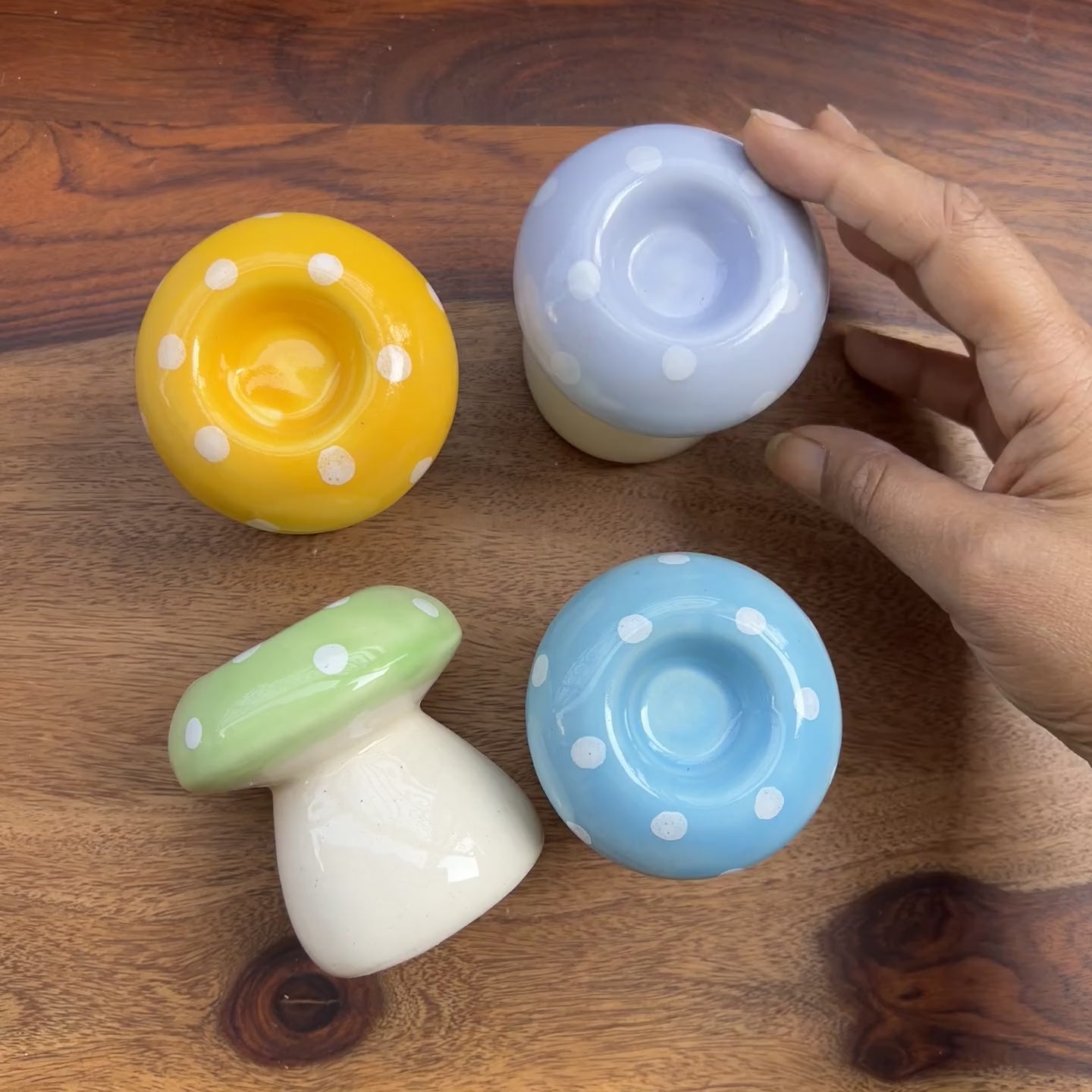 Product video of mushroom shaped candle holders in multiple colors.