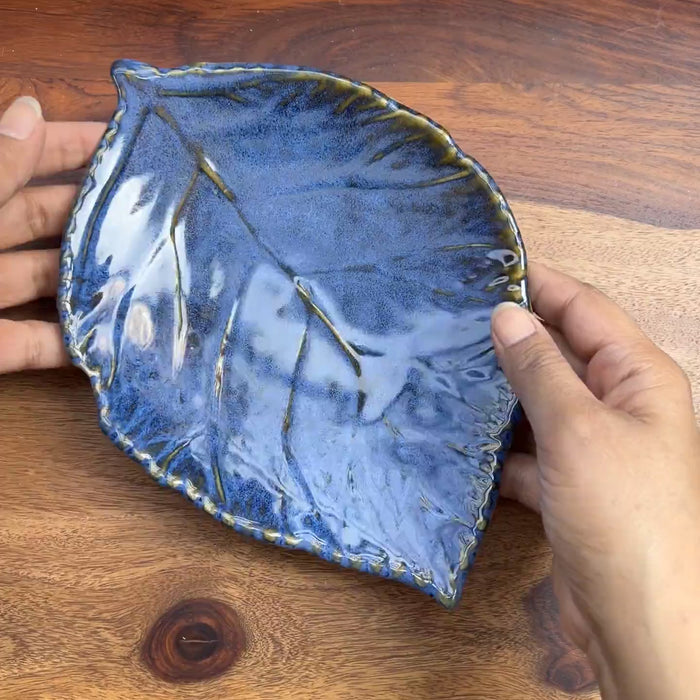 Product video of ceramic leaf in blue glaze with detailing.