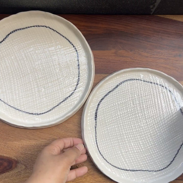 Product video of white ceramic plates with criss-cross texture.