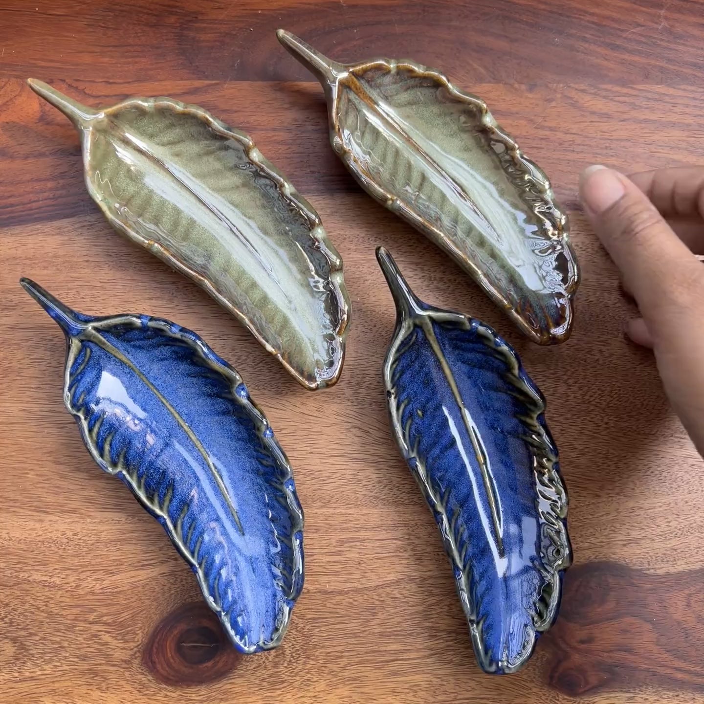 Product video of green ceramic leaf.