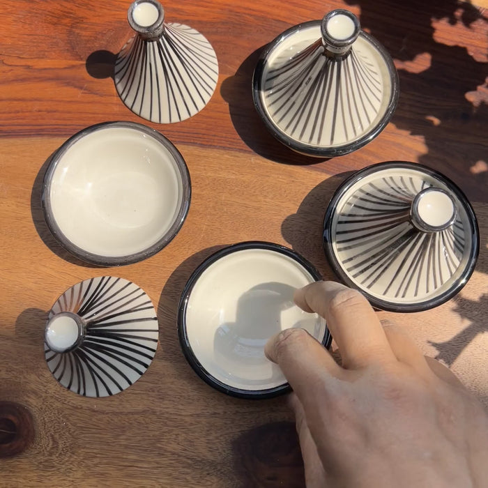 Product video of black and white tagine serveware.