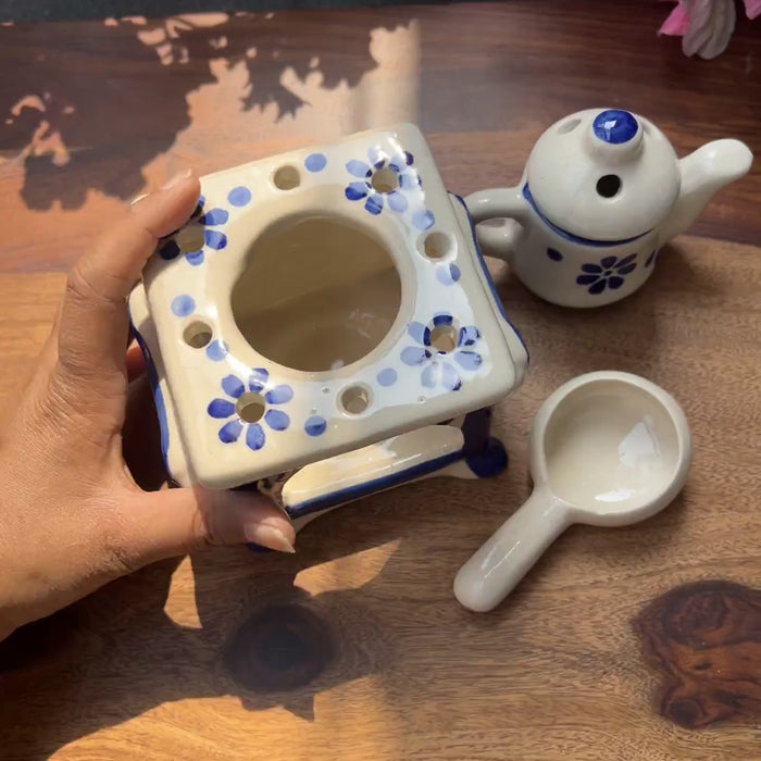 Product video of ceramic aroma diffuser with candle holder and kettle.