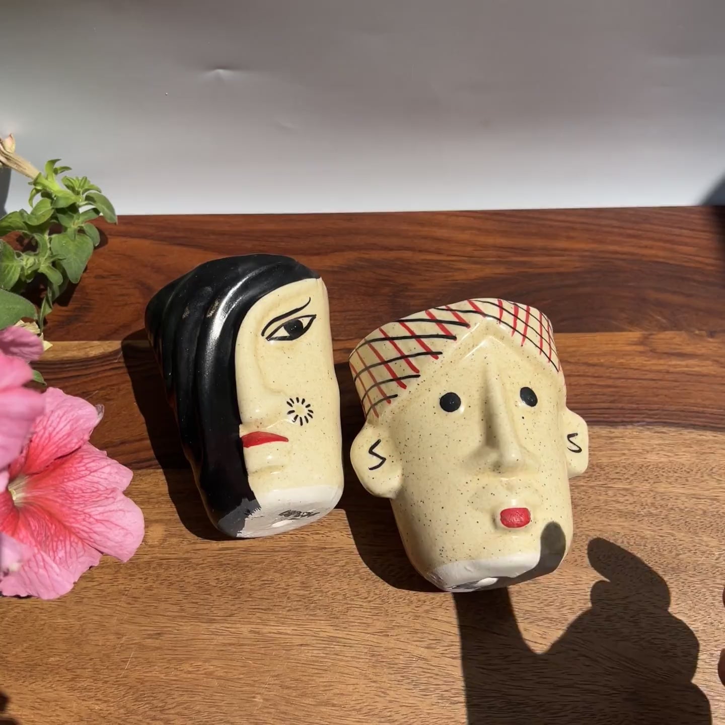 Product video of Indian face planters of a man and woman showing the intricate hand painted details; perfectly sized for desks and balcony garden.