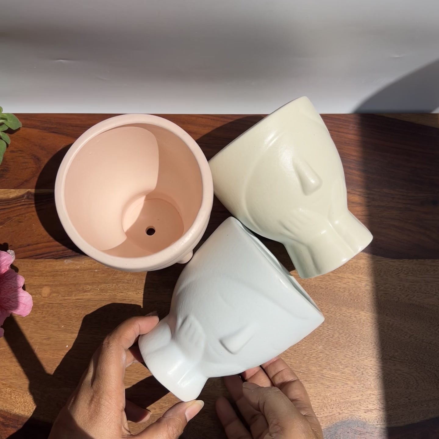 Product video of colourful nordic face desk planters - soothing pastel colours of pink, blue and cream.