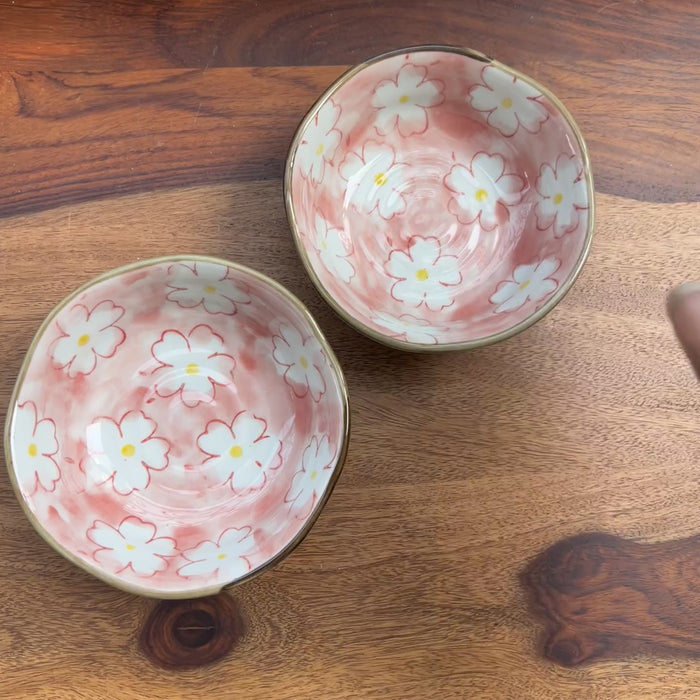 Product video of porcelain bowl in pink with white cherry blossom design.