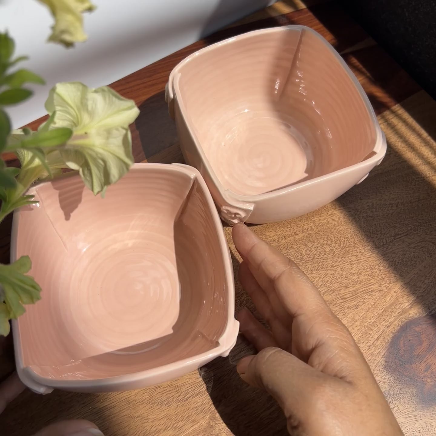Unedited raw video of the pink ceramic bowls showing the peachy glaze and finish in natural sunlight.