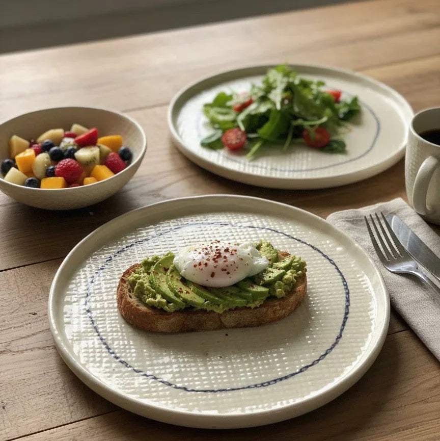 Morning toast; a beautifully plated sourdough slice on the textured plate next to a linen napkin.