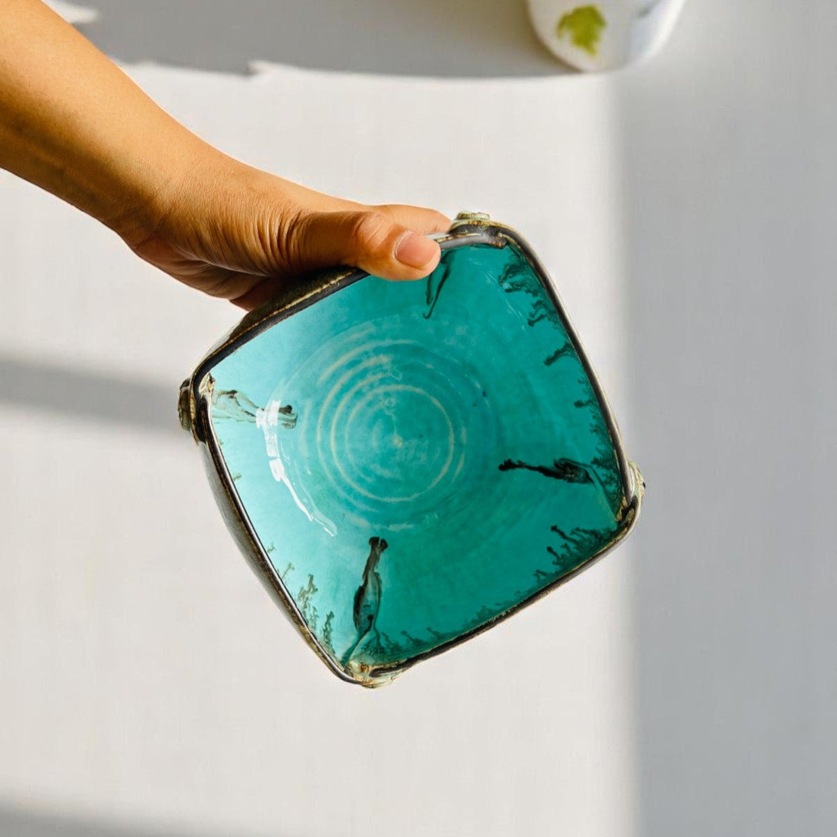 Hand holding blue ceramic bowl, large capacity bowl for family meals and holiday gatherings.