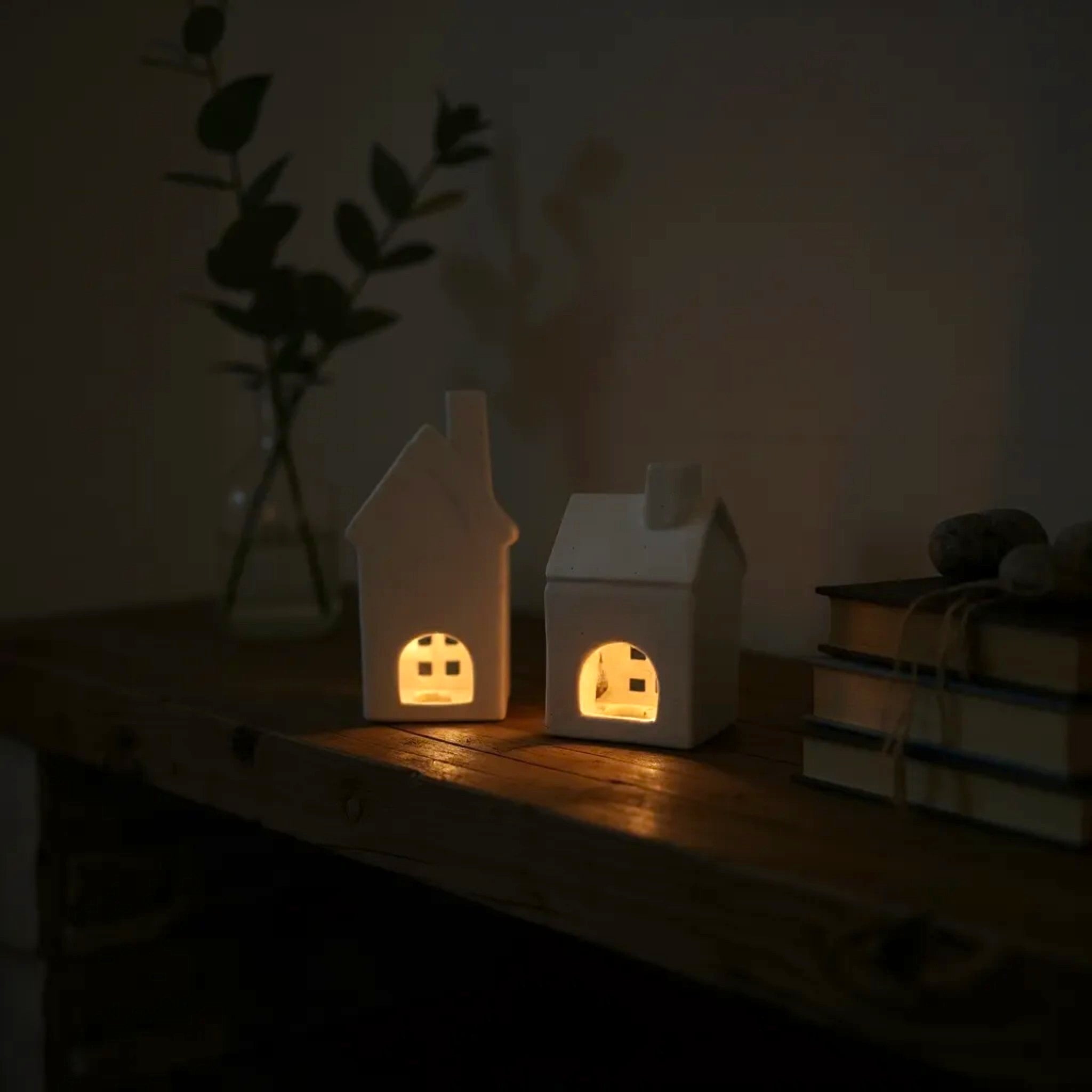 Back view of set of 2 ceramic houses glowing inside; unique housewarming gift and serene tabletop centerpieces.