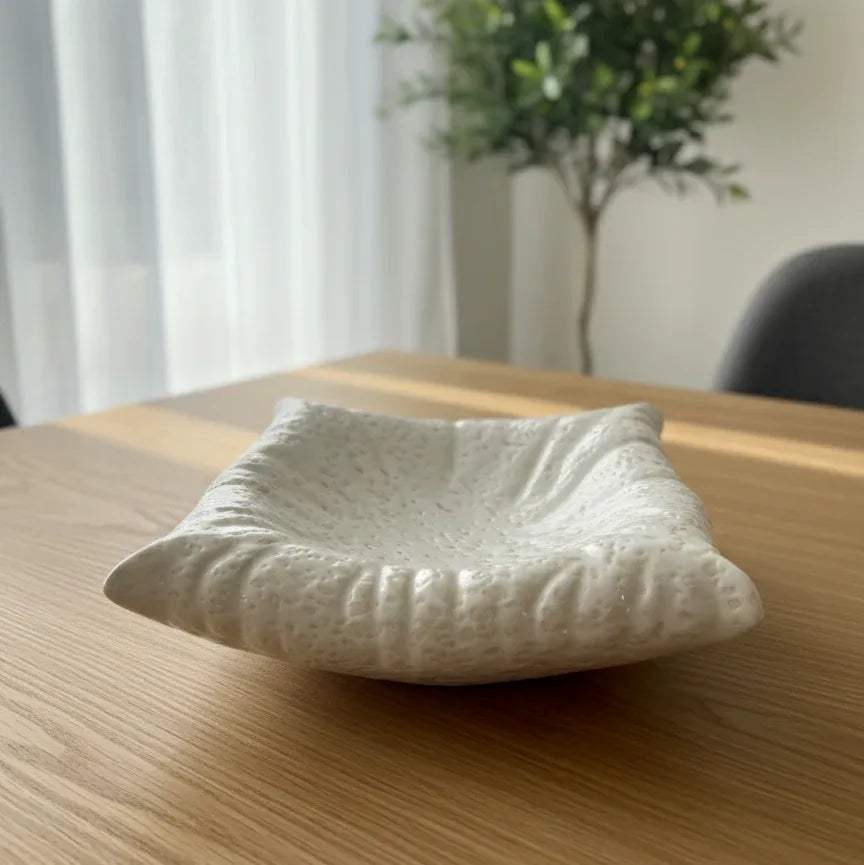Wavy ceramic platter on a coffee table; unique wedding gift idea and aesthetic centerpiece for jewelry.