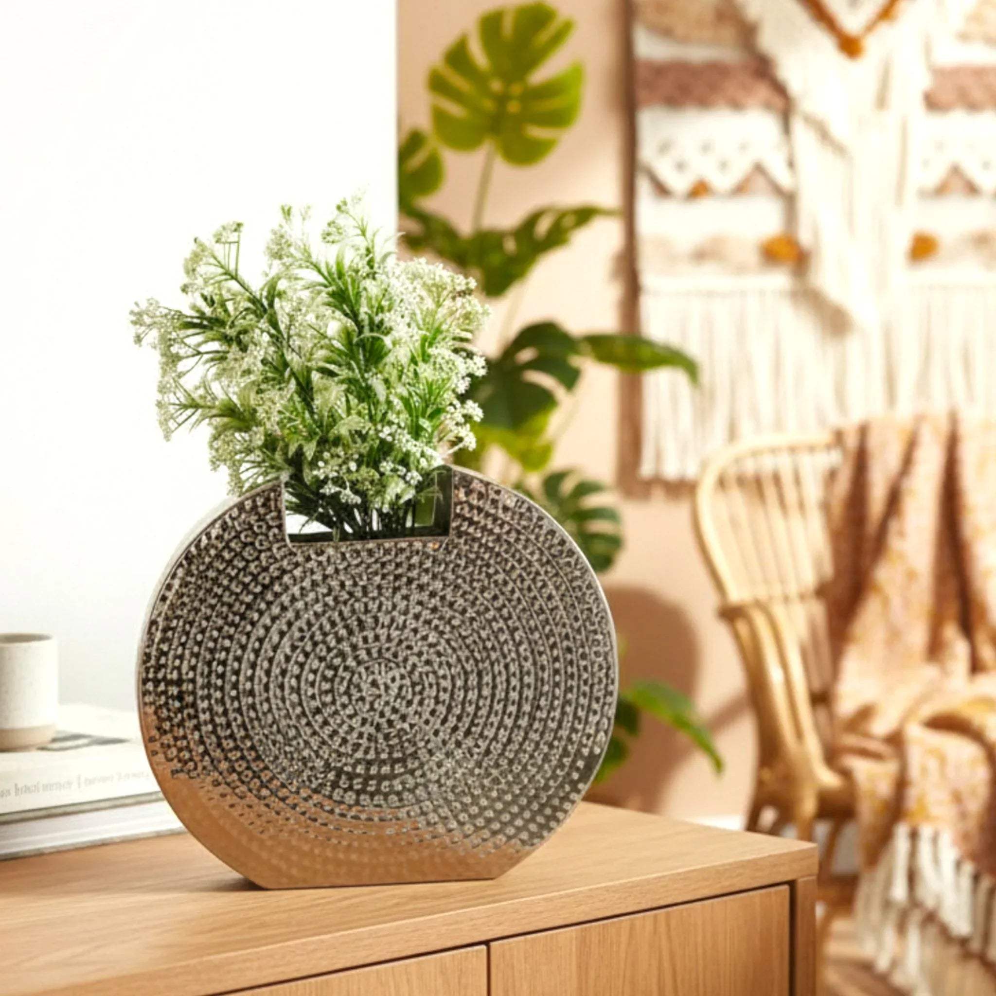 Metallic vase with artificial flowers; unique gift for art collectors and luxury home decor statement ideas.