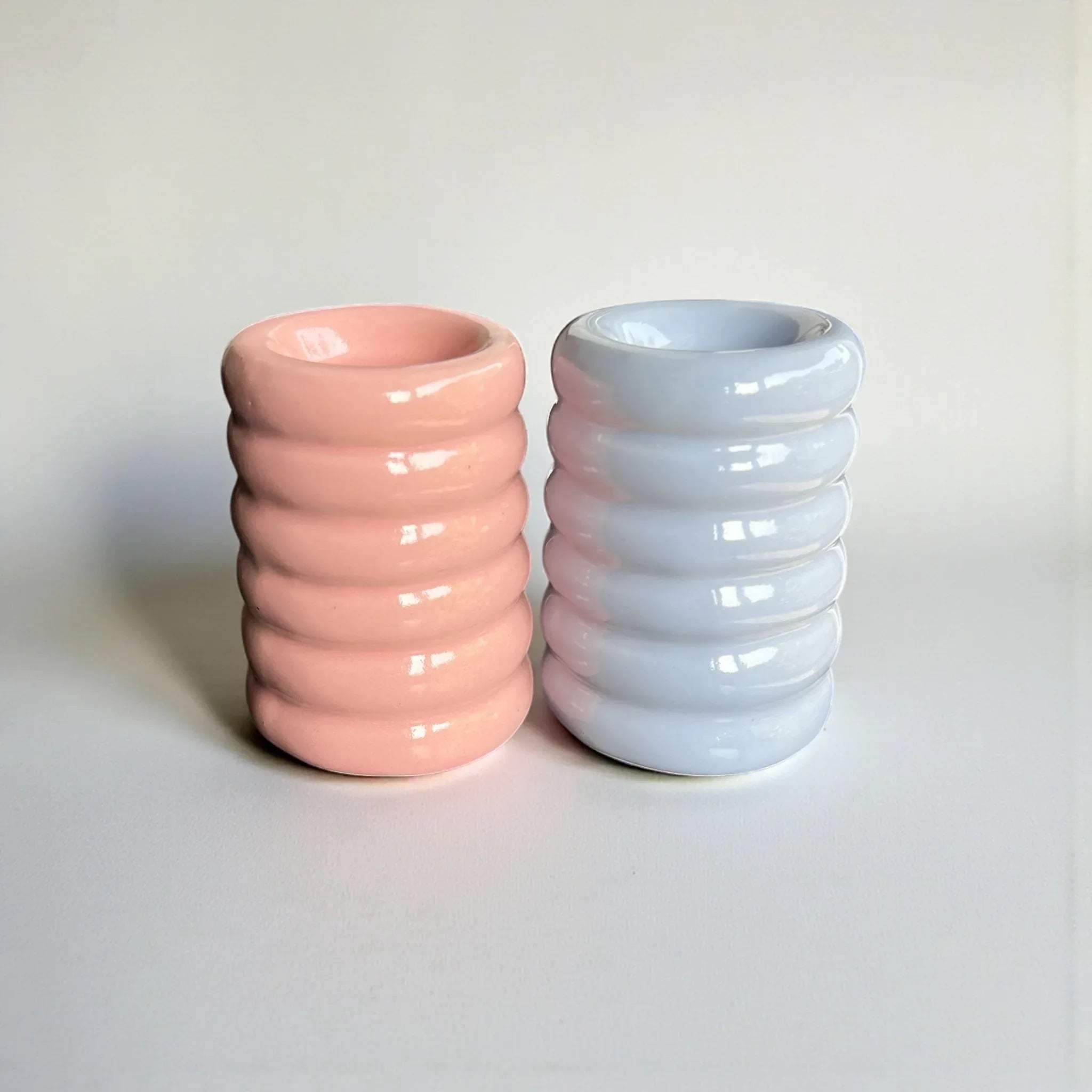 Pair of pastel pink and purple candle holders; unique gift for housewarmings and cute, modern apartment styling ideas.