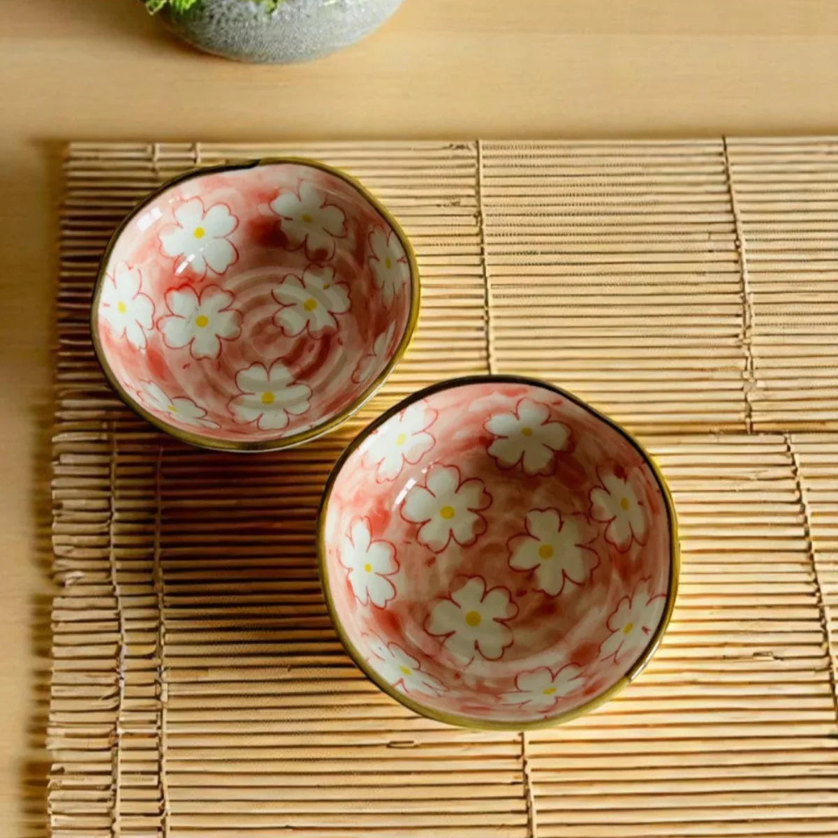 Sakura Serenity Bowl Set; two pink porcelain bowls with delicate cherry blossom designs and a glossy finish.