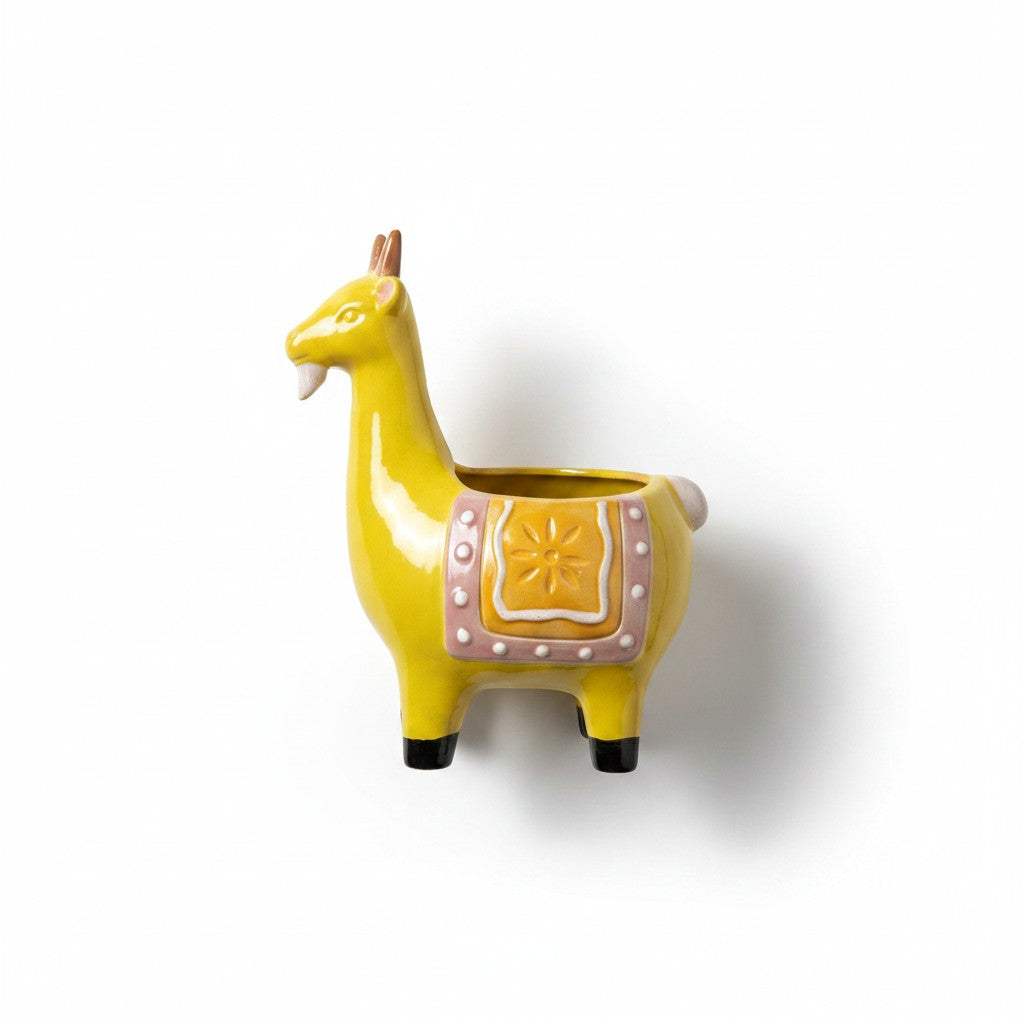 Close-up view of the detailed hand-painted saddle motif and smooth gloss finish on the yellow ceramic goat pot.