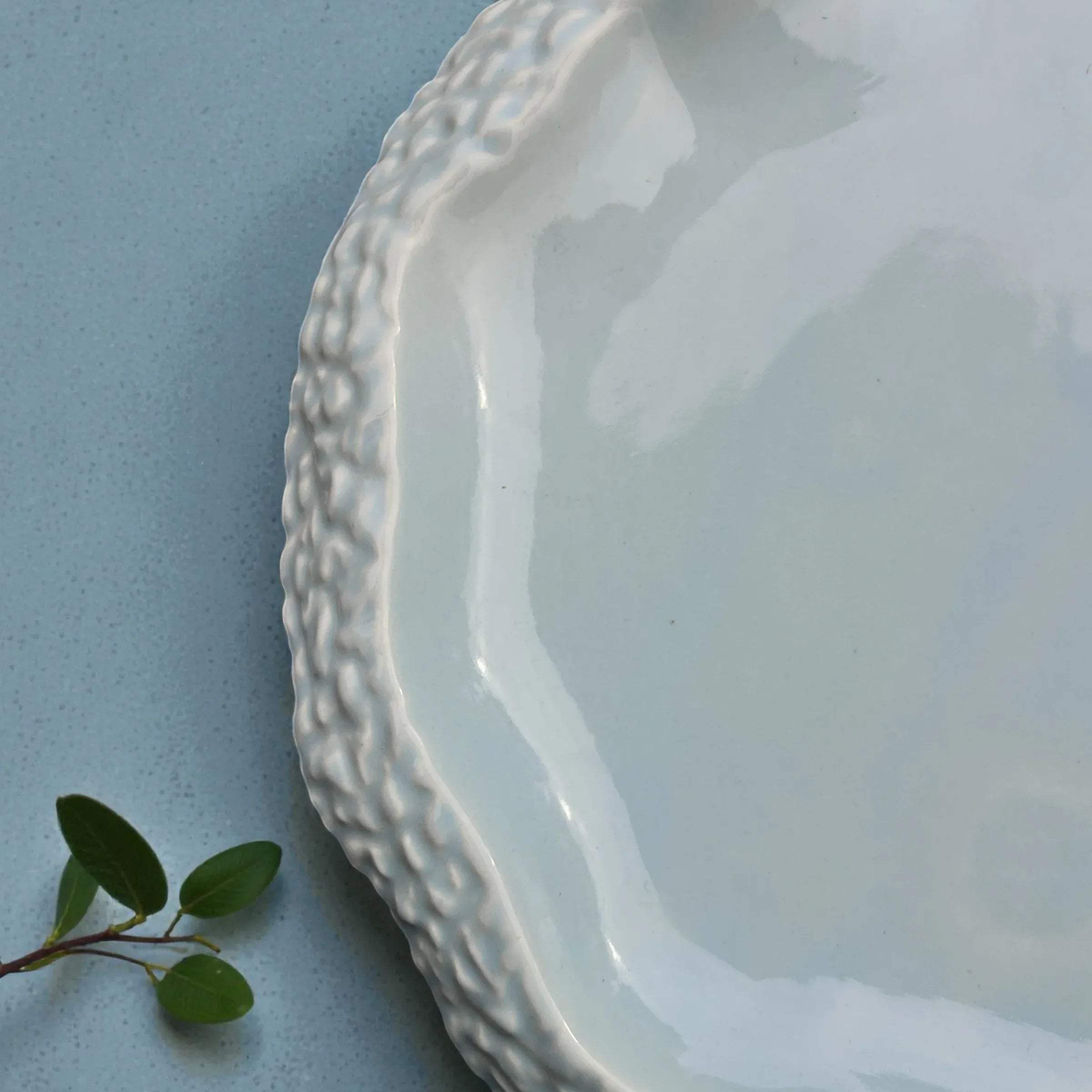 Texture close-up; showing the "pebble" undulations and the soft, nature-inspired seafoam blue artisan glaze.