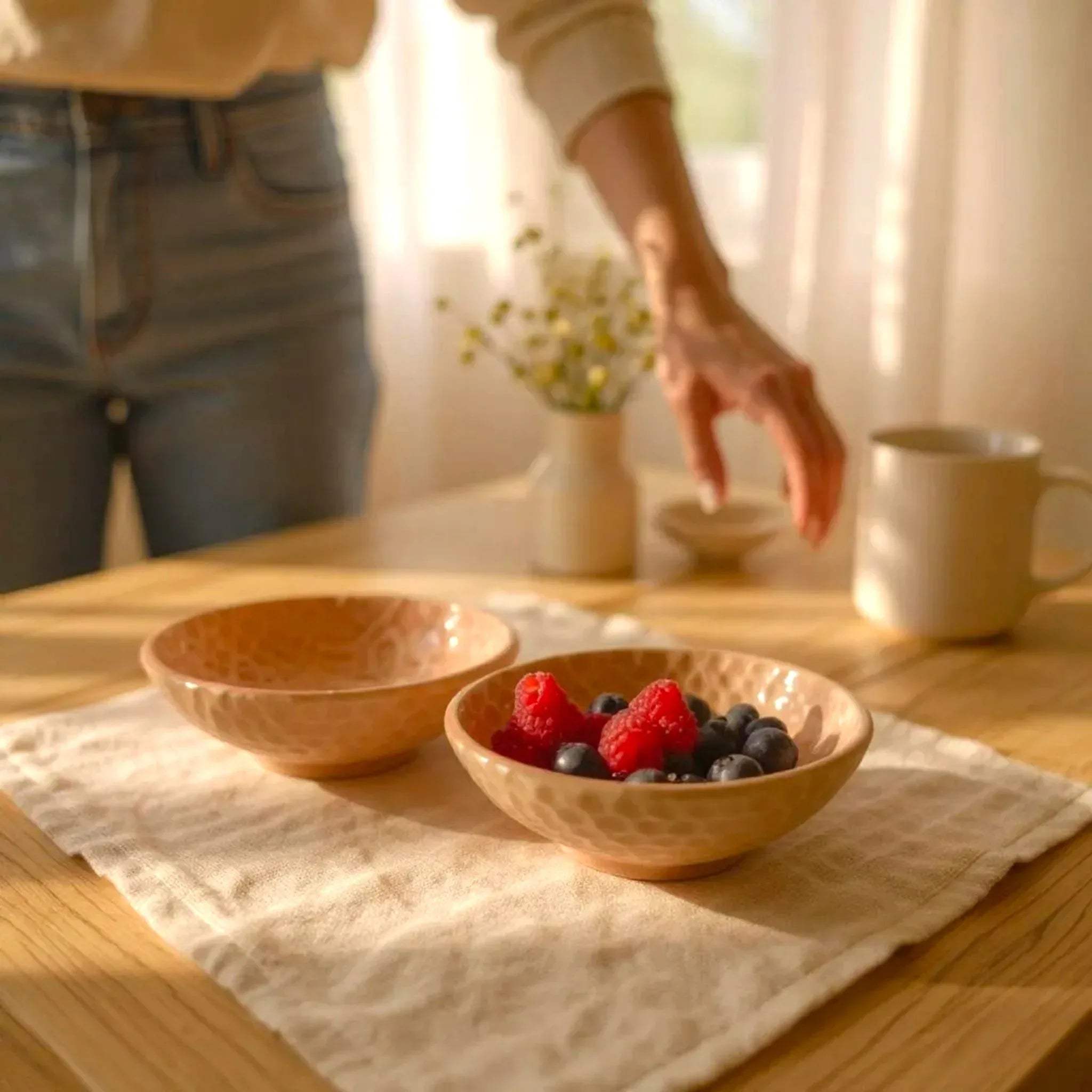 Evening snack setup; the bowls filled with roasted nuts and olives next to a glass of wine for a cozy night in.