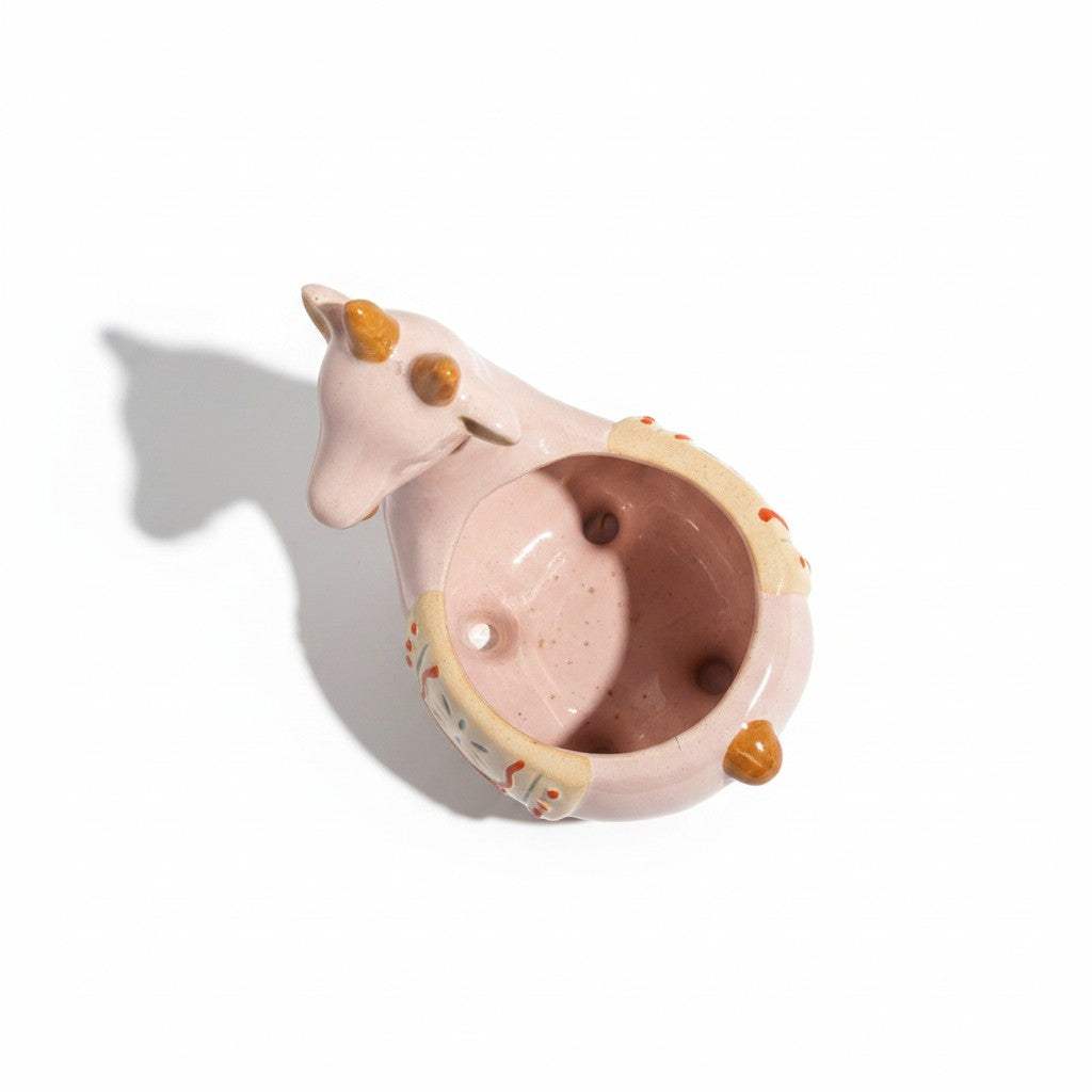 Bottom view showcasing the hole-free solid leakproof base of the pink ceramic planter to keep home furniture dry.