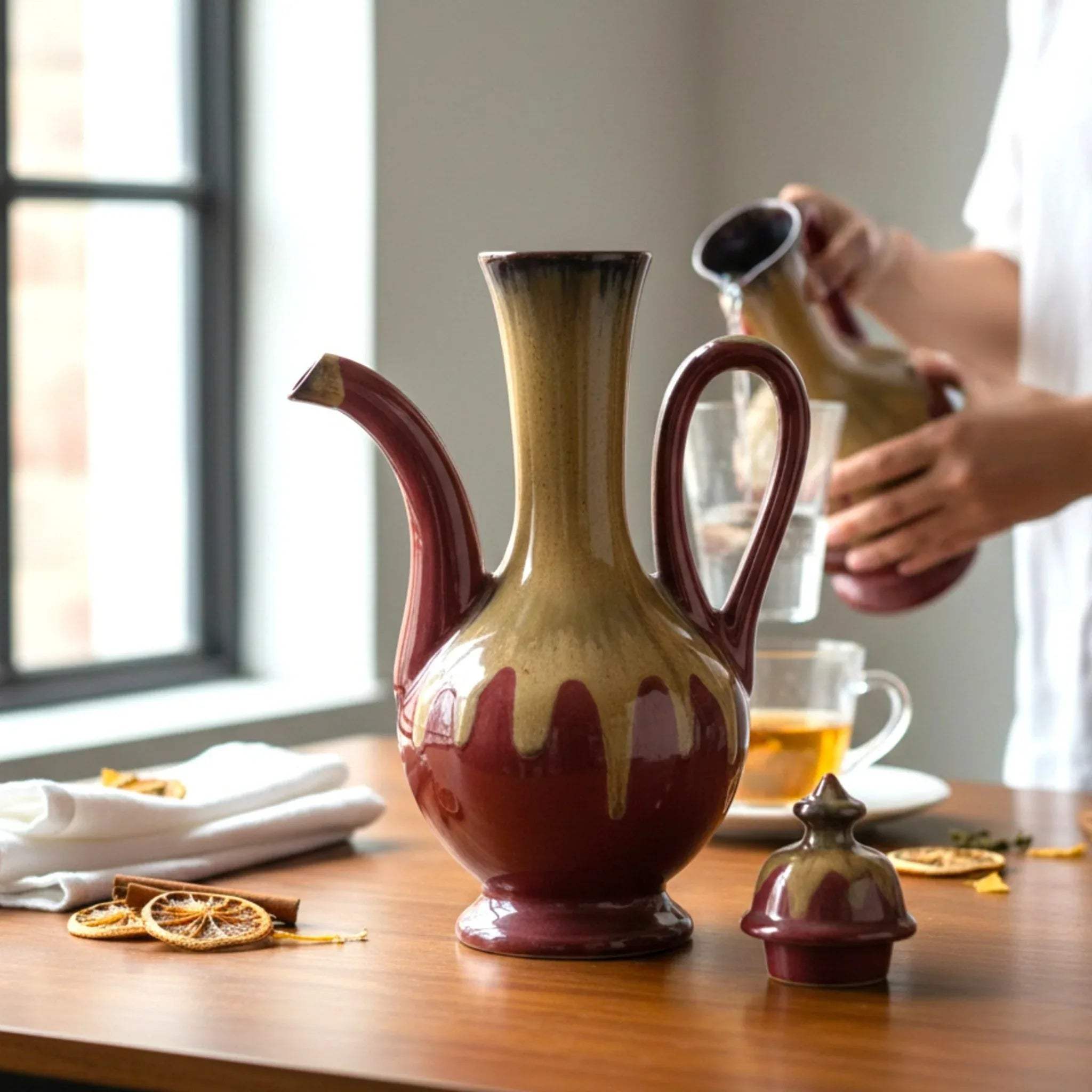 Glaze depth; a close-up showing the gradient of red hues and the smooth, ergonomic neck of the vessel.