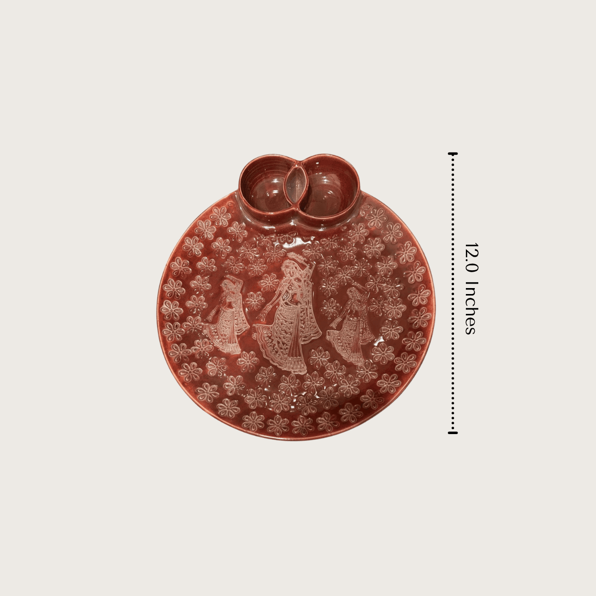 Product measurement diagram showing the 12 inches diameter and depth dimensions of the round ceramic folk-art serving platter.