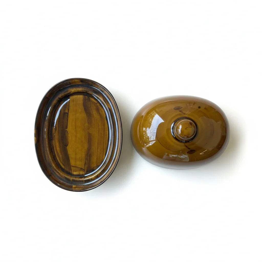 Top view of the smooth butter dish showing dark ceramic base plate and smooth lid.