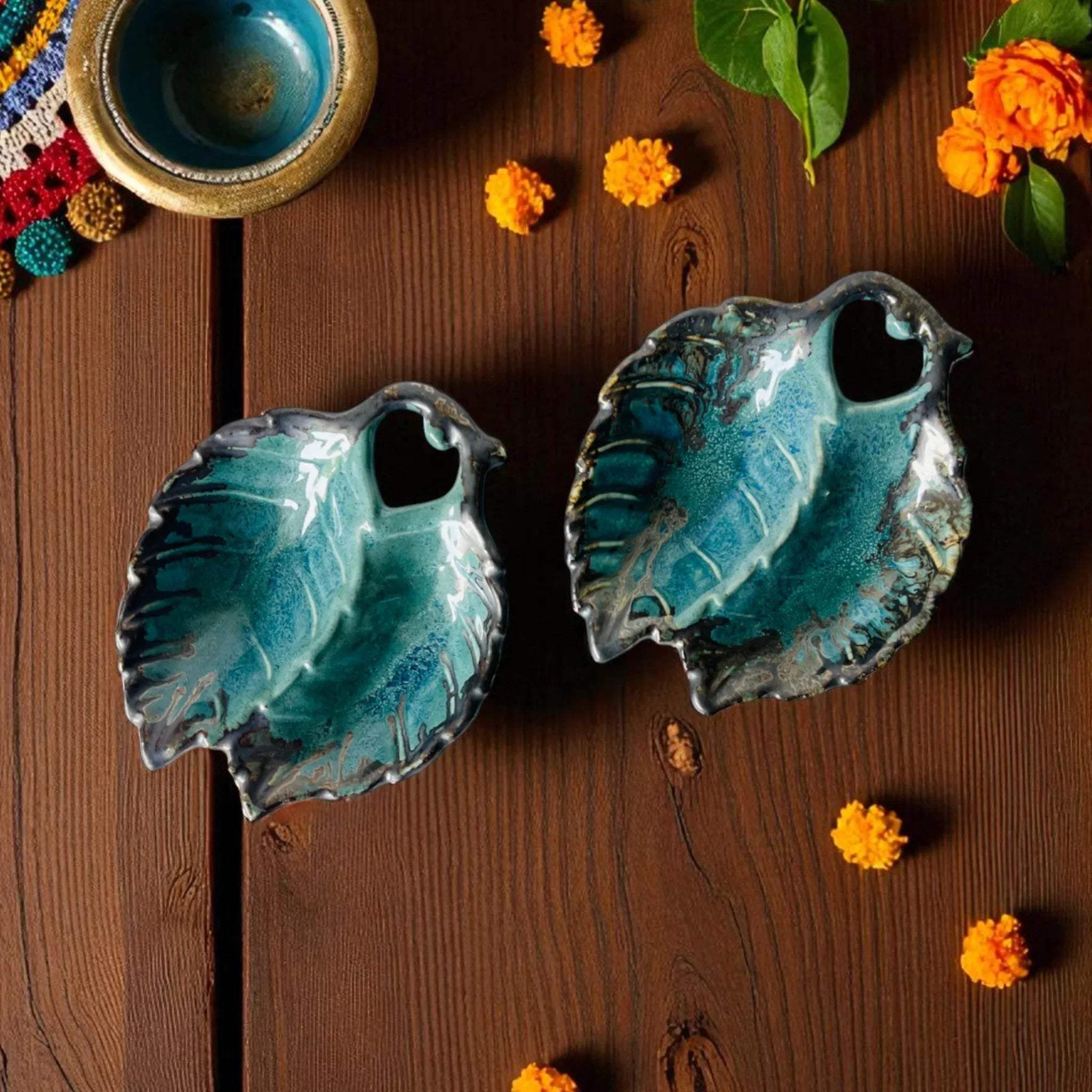 Traditional Puja setting; the divided ceramic tray for holding roli and chawal next to flowers.